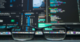 glasses in foreground with data processing on screens behind it
